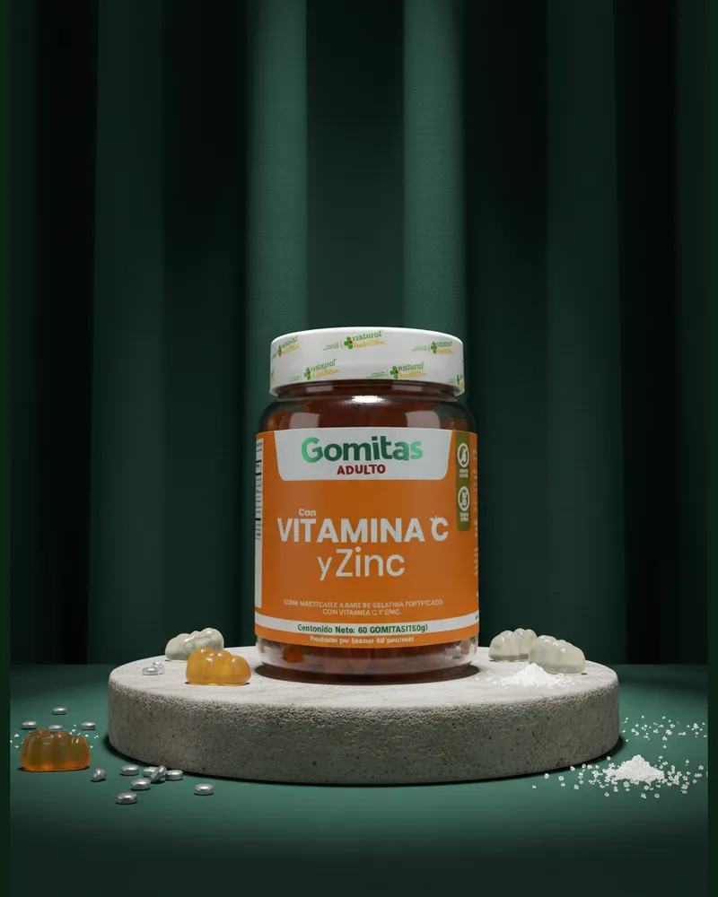 Gomitas de vitamina C y zinc sobre una piedra en un estudio verde, con sus ingredientes